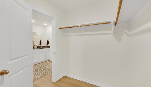 walk in closet featuring light hardwood / wood-style flooring