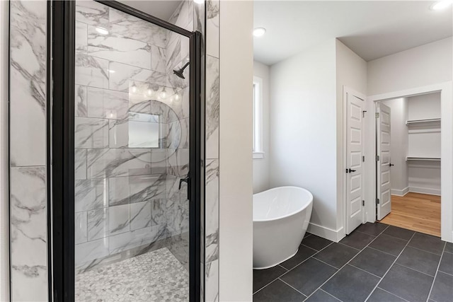 bathroom with tile patterned floors and shower with separate bathtub