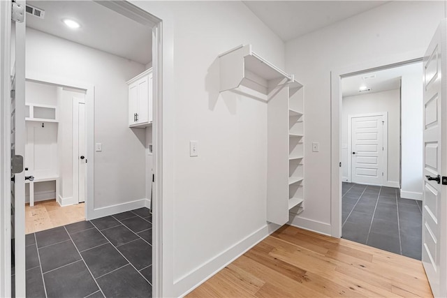 walk in closet featuring dark tile patterned flooring