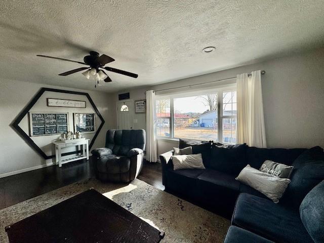 living room featuring ceiling fan, a textured ceiling, and hardwood / wood-style flooring