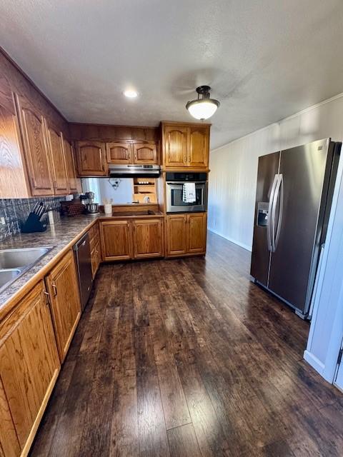 kitchen featuring sink, dark hardwood / wood-style floors, range hood, tasteful backsplash, and stainless steel appliances