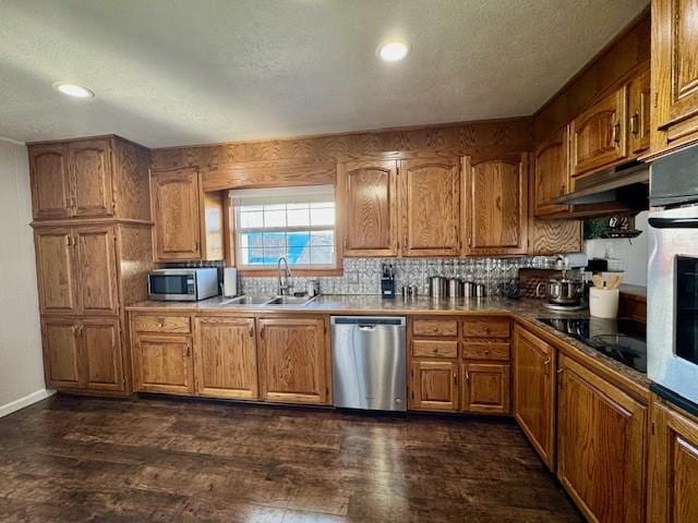 kitchen with dark hardwood / wood-style floors, sink, stainless steel appliances, and tasteful backsplash