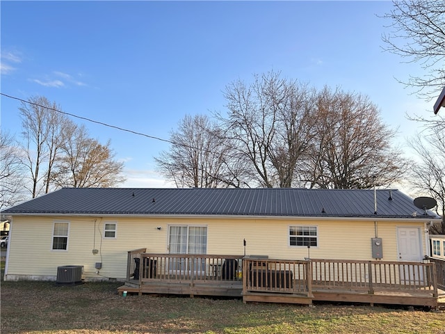 rear view of house featuring a yard and a deck