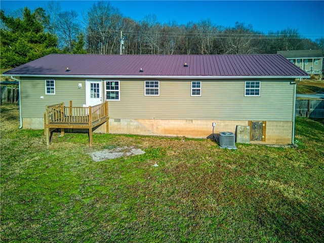 back of house featuring a wooden deck, a yard, and central AC