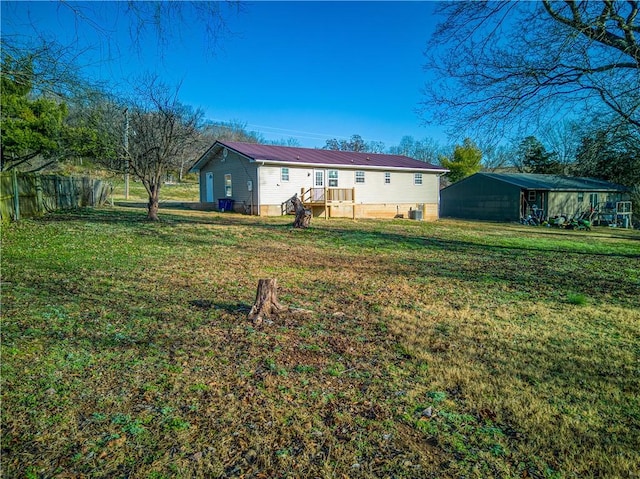 rear view of house featuring a yard