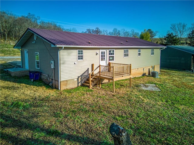 back of property featuring central AC, a wooden deck, and a lawn