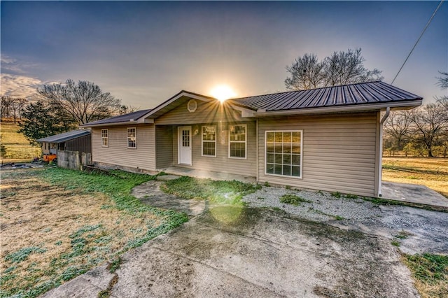 back house at dusk with a carport