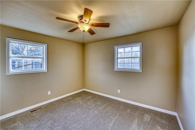 carpeted empty room featuring ceiling fan