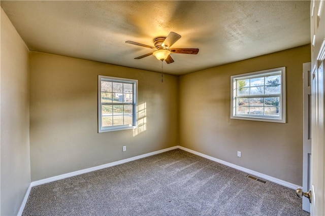 empty room featuring carpet flooring, ceiling fan, and a textured ceiling