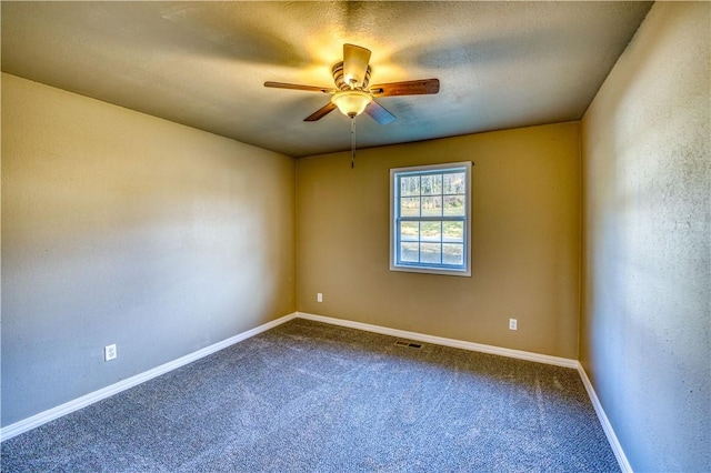 spare room featuring ceiling fan, carpet floors, and a textured ceiling