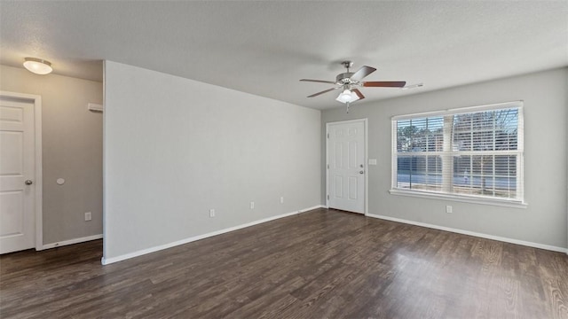 spare room featuring dark hardwood / wood-style floors and ceiling fan