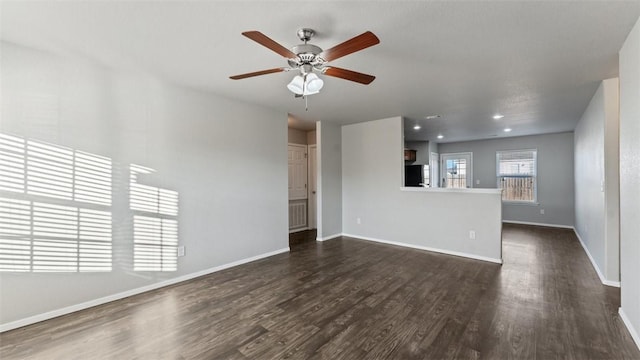 unfurnished living room featuring ceiling fan and dark hardwood / wood-style flooring