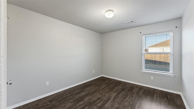 empty room featuring dark hardwood / wood-style flooring