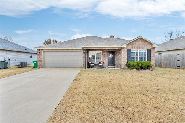 ranch-style house featuring central AC, a front lawn, and a garage