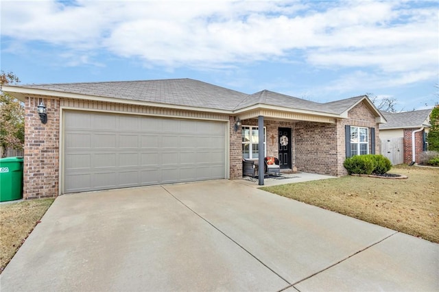 single story home featuring a garage and a front lawn