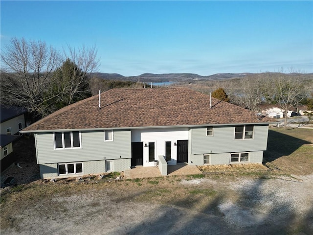 rear view of property featuring a mountain view