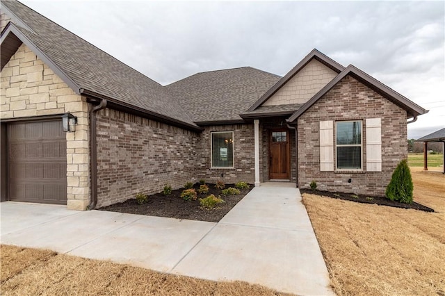 256 Fiori St, Springdale, AR 72762 - craftsman-style home featuring an attached garage, roof with shingles, brick siding, and driveway