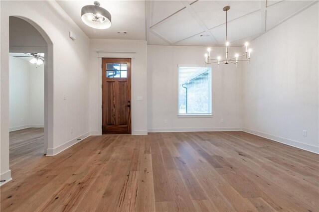 foyer featuring light hardwood / wood-style floors and ceiling fan with notable chandelier