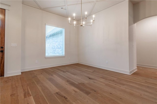 unfurnished dining area with hardwood / wood-style floors and a chandelier