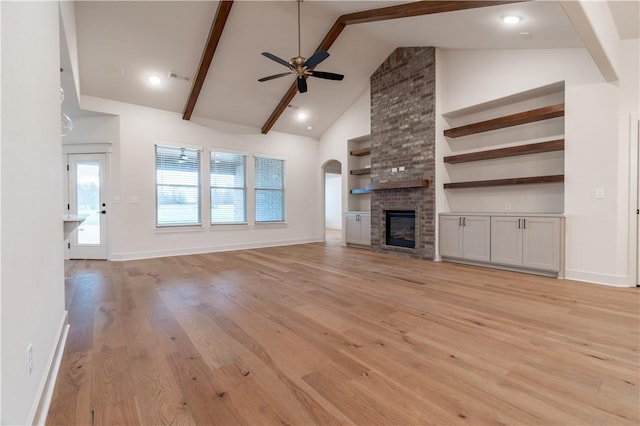 256 Fiori St, Springdale, AR 72762 - unfurnished living room with ceiling fan, light wood finished floors, beamed ceiling, high vaulted ceiling, and a brick fireplace