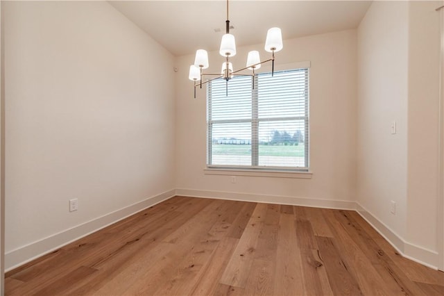 256 Fiori St, Springdale, AR 72762 - empty room with a chandelier and light wood-style flooring