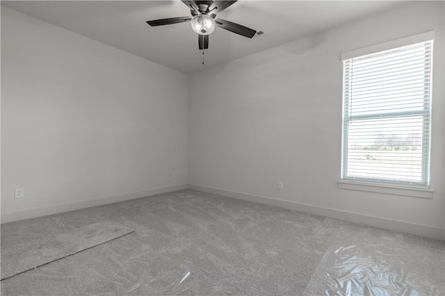 carpeted spare room with ceiling fan