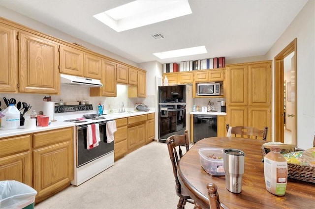 kitchen featuring stainless steel microwave, white range with electric cooktop, sink, tasteful backsplash, and light colored carpet