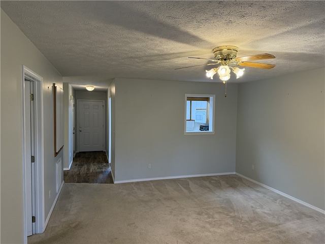 empty room featuring carpet, ceiling fan, and a textured ceiling