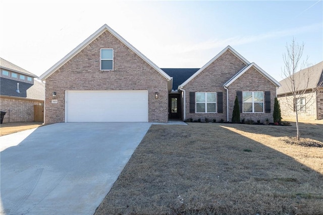 view of front of house featuring a garage and a front lawn