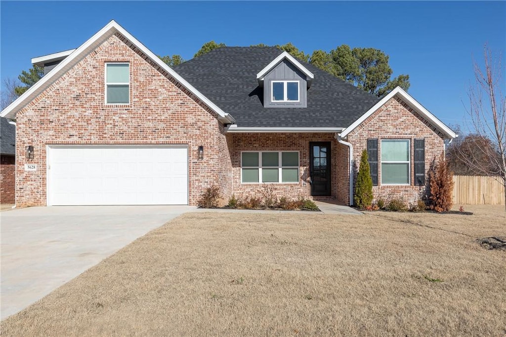 front facade with a garage and a front yard