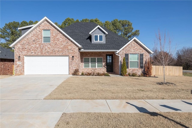 view of property featuring a garage and a front lawn