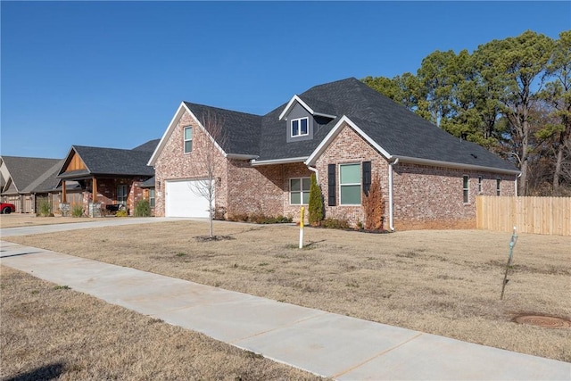 view of front of home featuring a garage and a front lawn