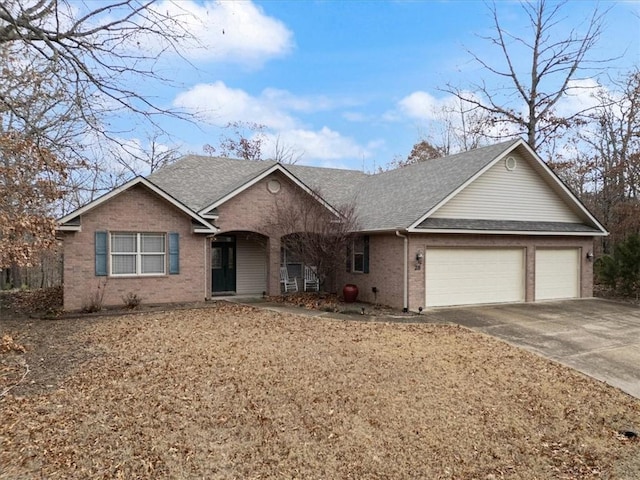 ranch-style home with a porch and a garage