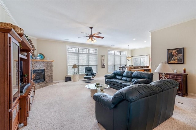 living room featuring a stone fireplace, crown molding, ceiling fan, and light colored carpet