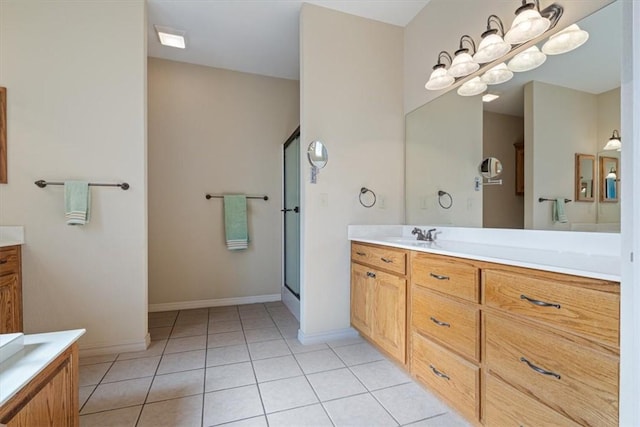 bathroom featuring vanity, tile patterned floors, an enclosed shower, and a notable chandelier