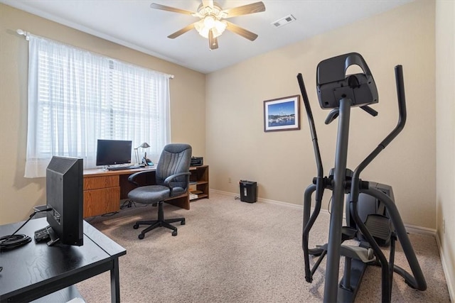 carpeted home office with ceiling fan