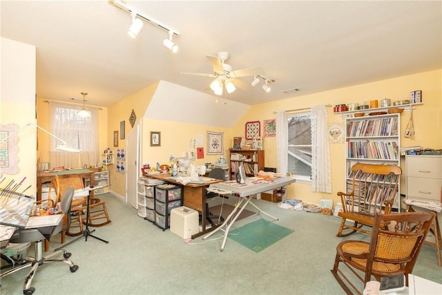 carpeted home office featuring vaulted ceiling, ceiling fan, and track lighting