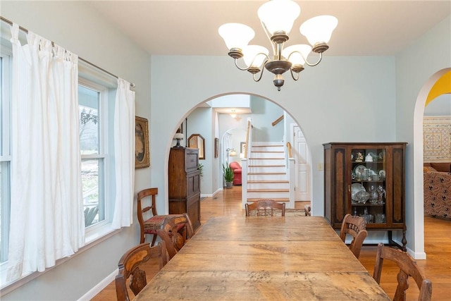 dining space with a chandelier and light hardwood / wood-style floors