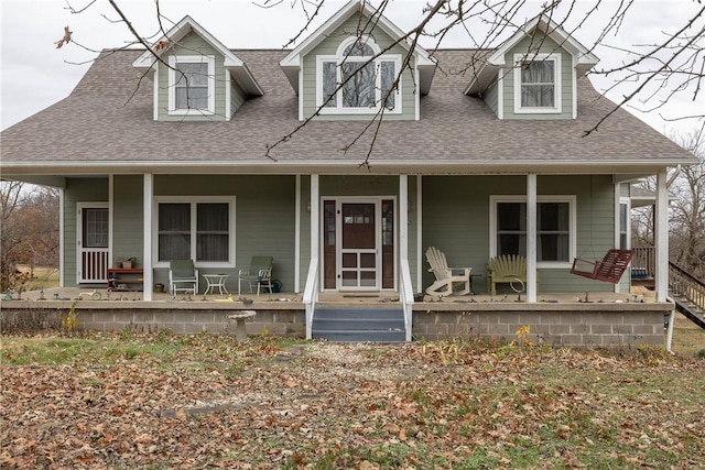 cape cod home featuring a porch