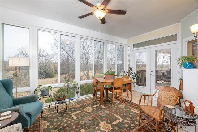 sunroom / solarium with ceiling fan and french doors