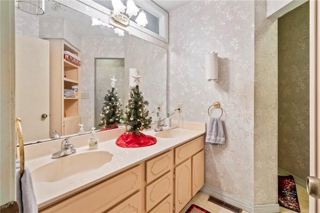 bathroom featuring tile patterned flooring, vanity, and a chandelier