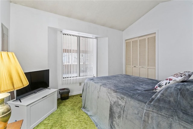 carpeted bedroom featuring lofted ceiling and a closet