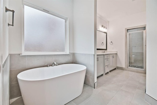 bathroom with shower with separate bathtub, vanity, and tile patterned floors