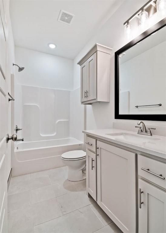 full bathroom with tile patterned flooring, vanity, toilet, and shower / washtub combination