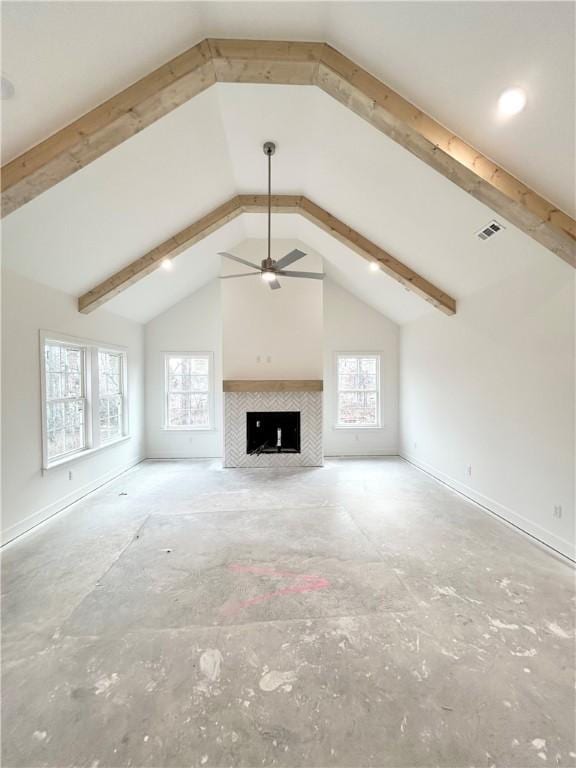 unfurnished living room with beam ceiling, a tiled fireplace, ceiling fan, and high vaulted ceiling