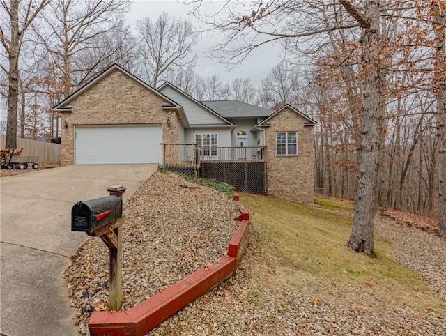 ranch-style home featuring a wooden deck, a front yard, and a garage