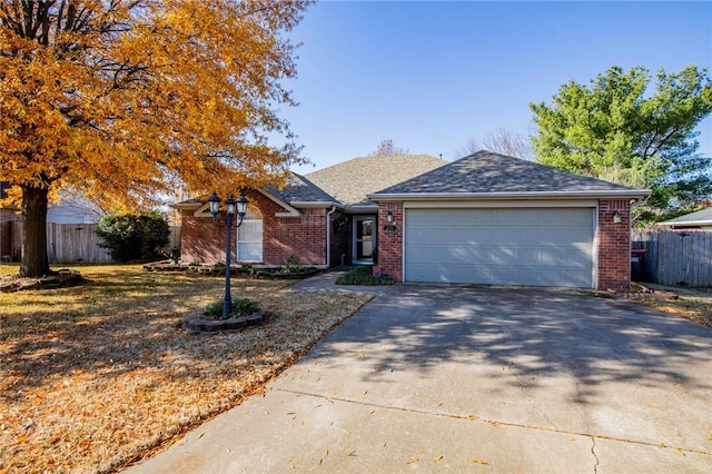 single story home featuring a garage and a front yard