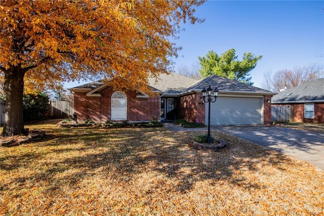 ranch-style home featuring a front yard and a garage