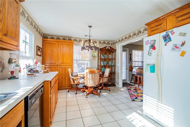 kitchen with dishwasher, a healthy amount of sunlight, white fridge with ice dispenser, and an inviting chandelier