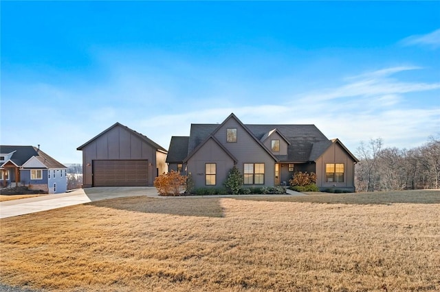 modern farmhouse featuring a front yard and a garage